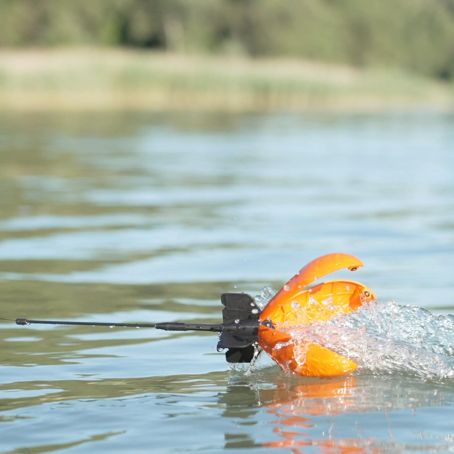 Winding out Advance Spyder Spod across water surface after emptying bait