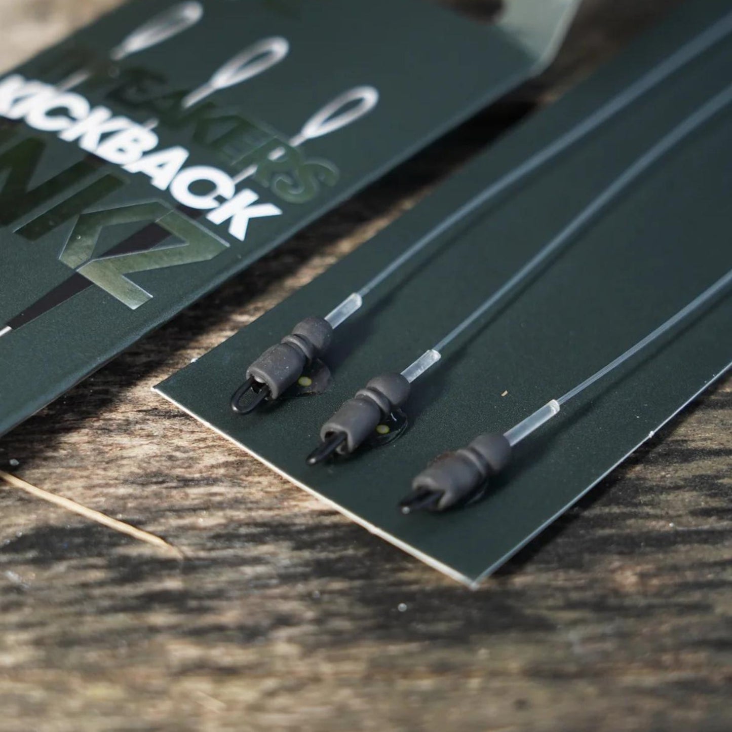 OMC Tweakers Kickback Linkz detail showing tungsten Dog Bone Ronnie Clip and Blend anti-tangle sleeve