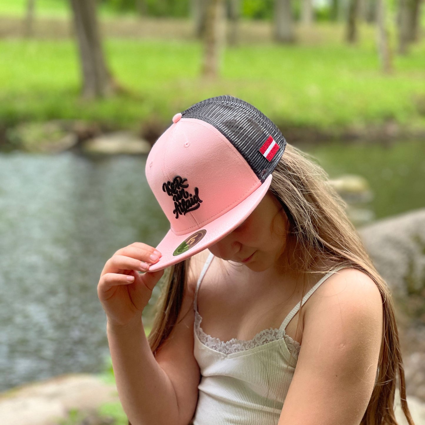 4Carpers Trucker Cap Pink Black – lifestyle photo by water