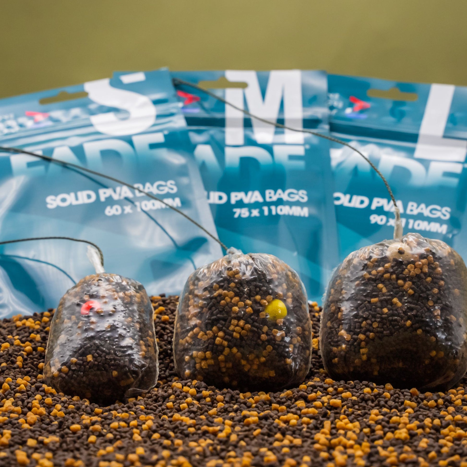 OMC FADE Solid PVA bags in all three sizes filled with bait for size comparison